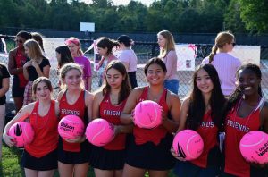 Several class of '25 tennis players pose with their senior day gifts.